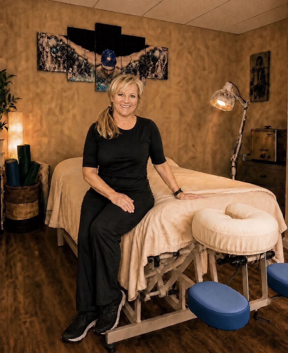 Belinda Hobbs seated on her massage table in her Memphis studio
